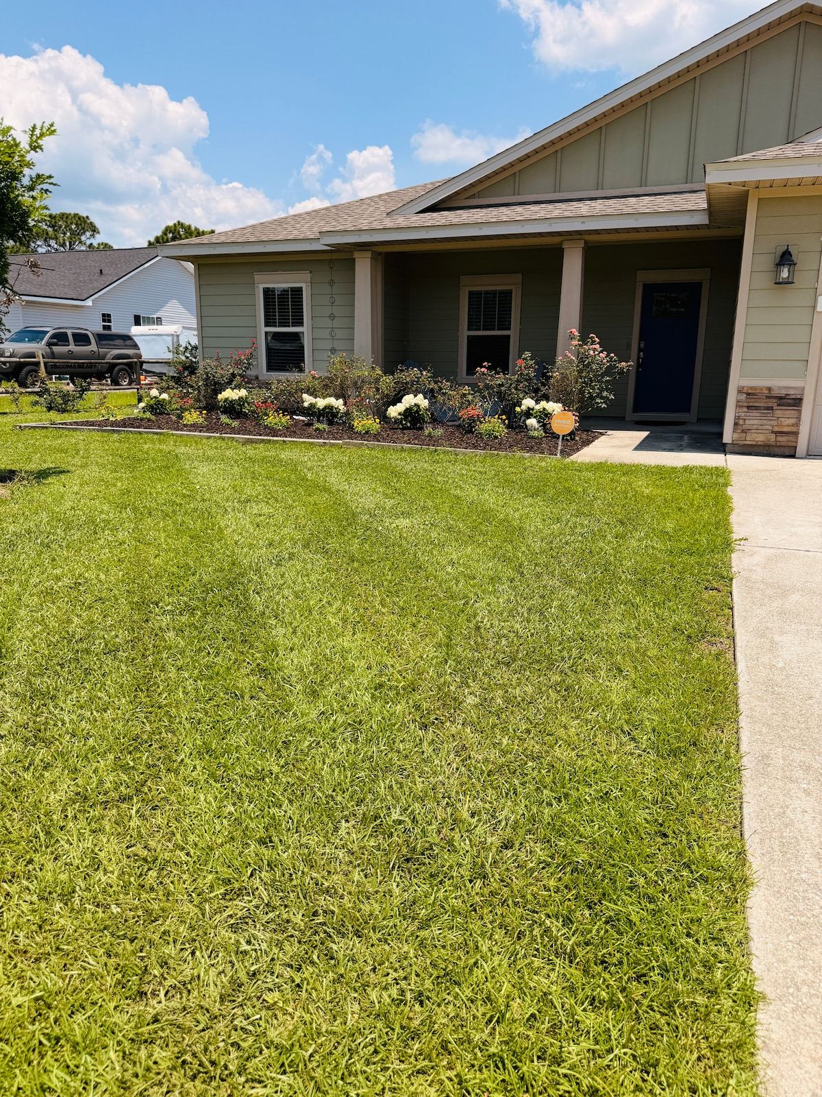 Front of the home with a large lawn